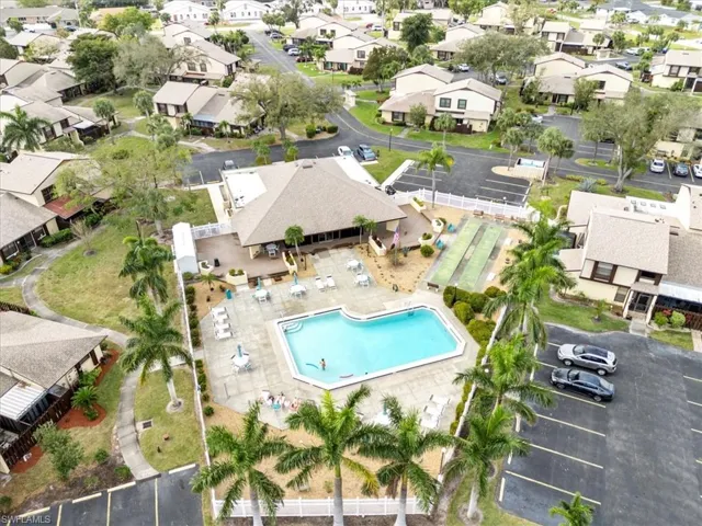 Aerial overview of property's location with a pool area and nearby suburban area