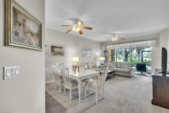 Dining area featuring a ceiling fan and carpet floors