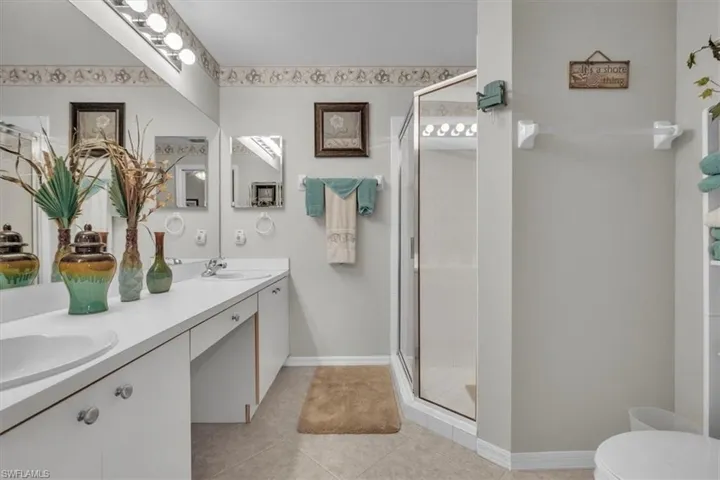 Bedroom featuring light colored carpet, a ceiling fan, and a closet