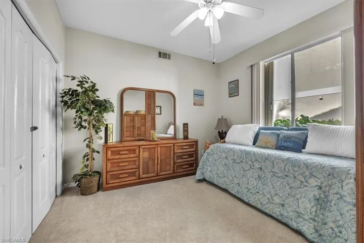 Bedroom with carpet flooring, a closet, and a ceiling fan