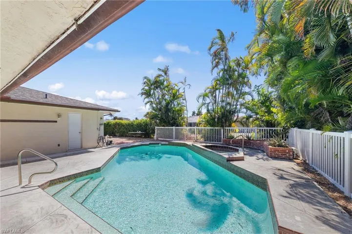 View of pool with patio surround and a fenced backyard