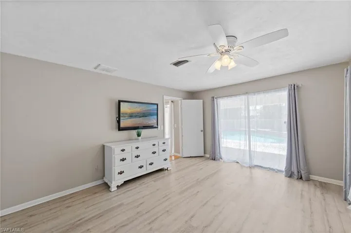 Spare room with a ceiling fan and light wood-style flooring