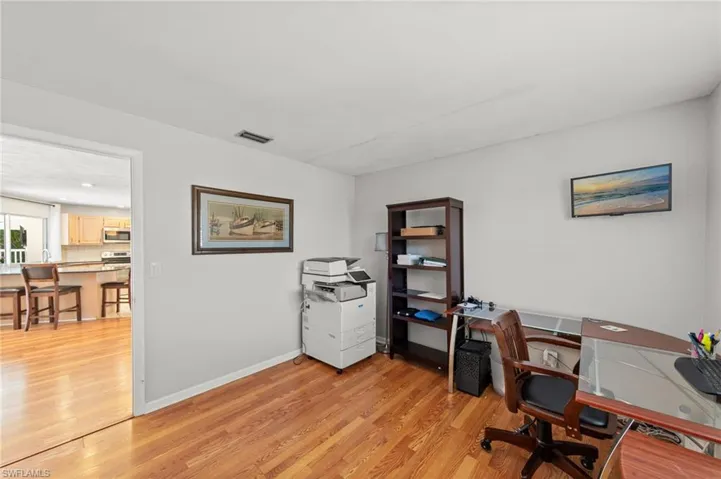 Office with light wood-style floors and baseboards
