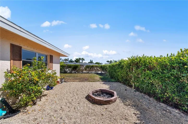 Fenced backyard with a fire pit