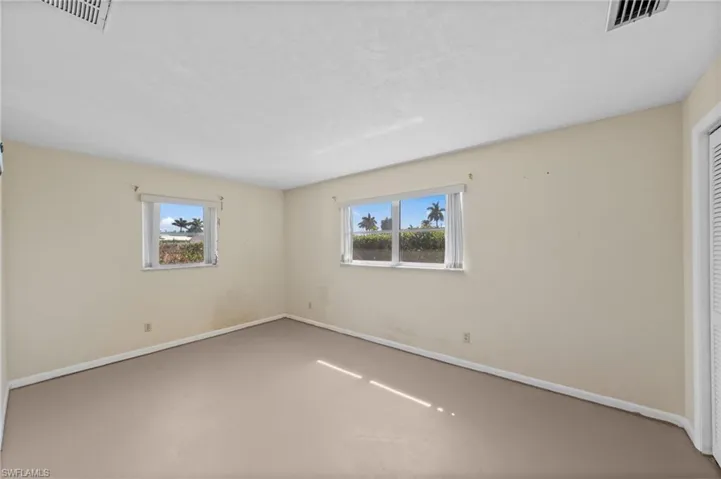 Empty room with healthy amount of natural light and concrete floors