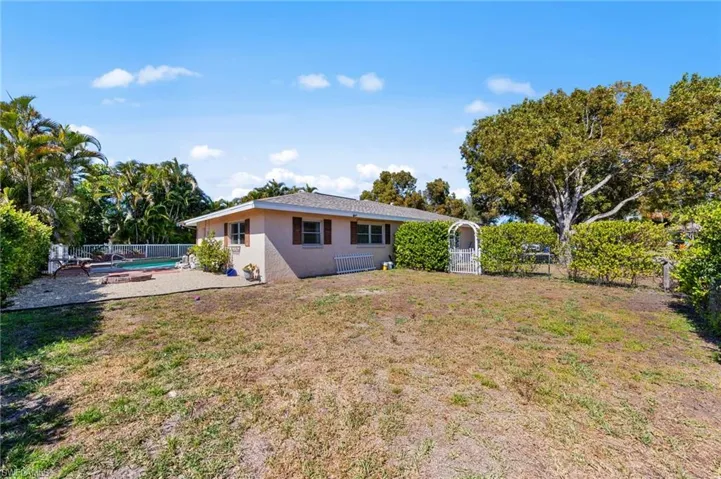 Rear view of property with a fenced backyard and stucco siding