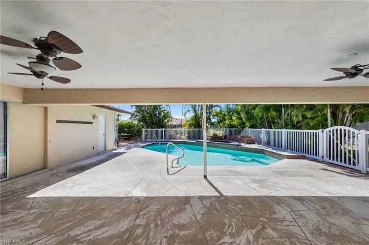 View of swimming pool featuring patio surround and a fenced backyard