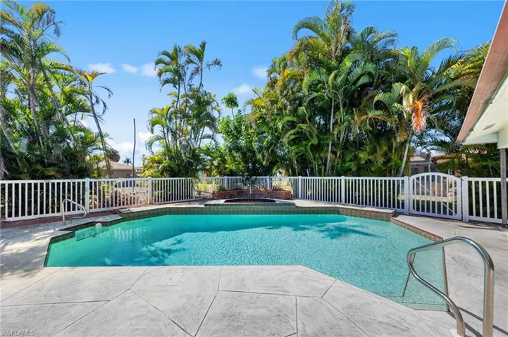 View of swimming pool with a fenced backyard and patio surround
