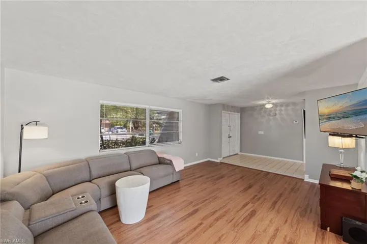 Living area with light wood finished floors and a textured ceiling