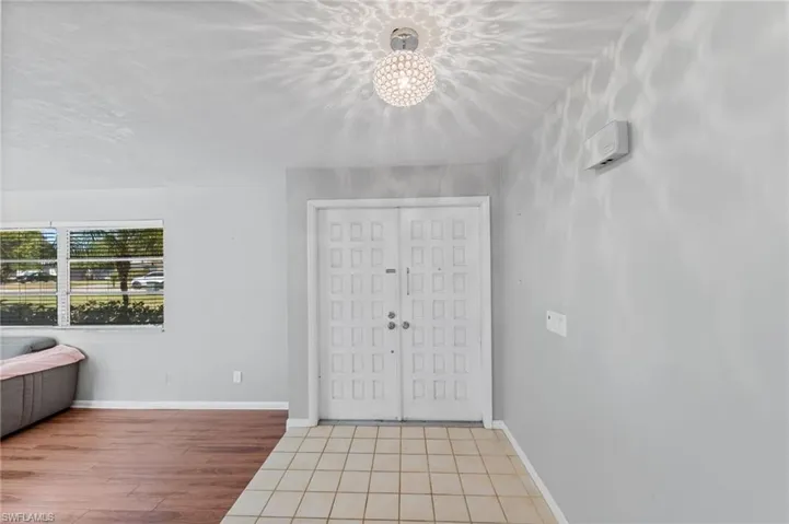 Entryway featuring light wood finished floors and hanging lights