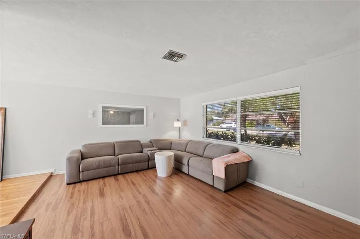 Living room with light wood-style floors and a textured ceiling