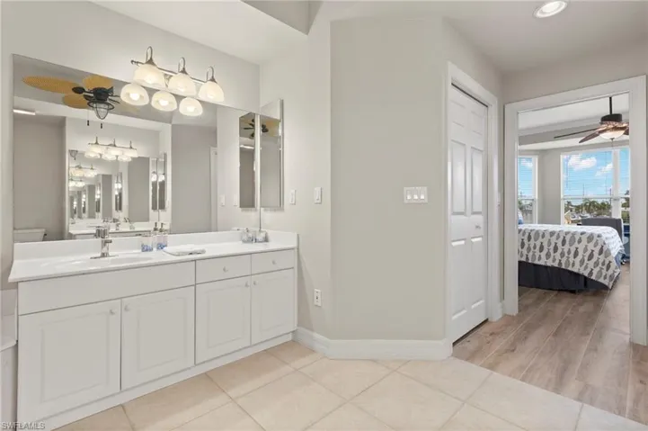 Bathroom featuring tile floors, ceiling fan, and vanity