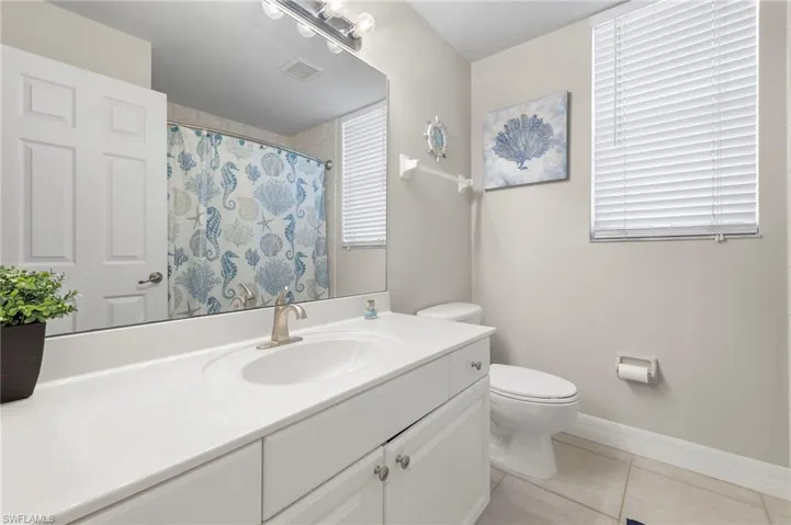 Bathroom with tile floors, toilet, and vanity