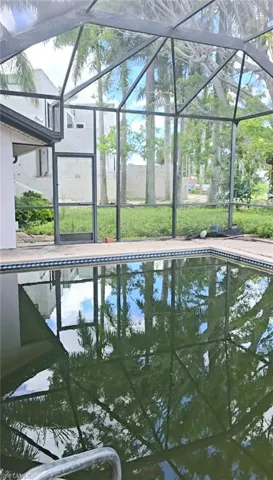 View of swimming pool with a lanai