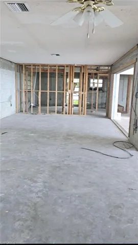Misc room with concrete floors, a healthy amount of sunlight, and ceiling fan