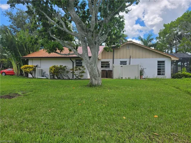 Rear view of property featuring a lawn