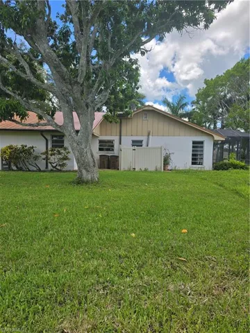 Rear view of property featuring a lawn