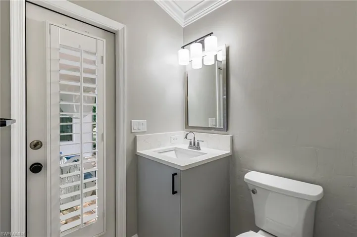 Bathroom featuring vanity and ornamental molding