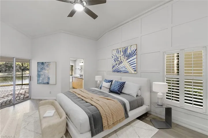 Virtually Staged-Bedroom with wood finished floors, crown molding, a ceiling fan, ensuite bathroom, and a decorative wall