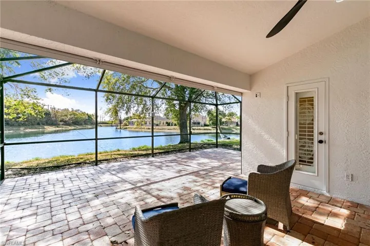 View of patio / terrace with a sunroom, a lanai, and a water view