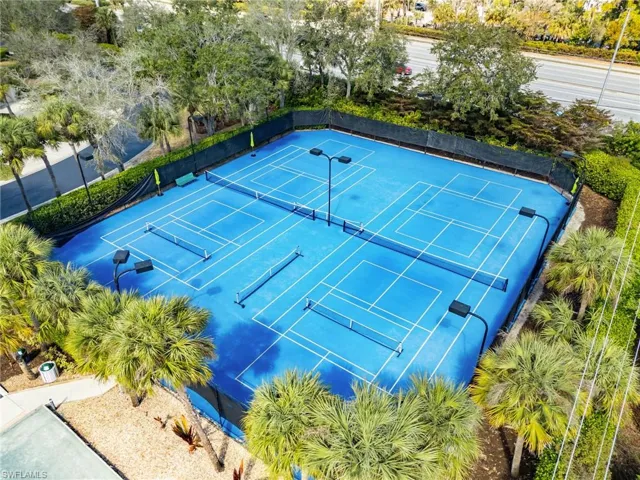 View of tennis court featuring a patio area