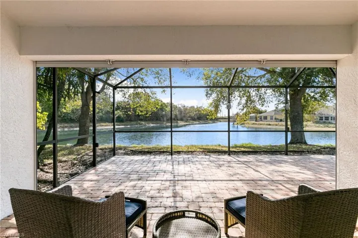 View of patio / terrace with a sunroom, glass enclosure, and a water view