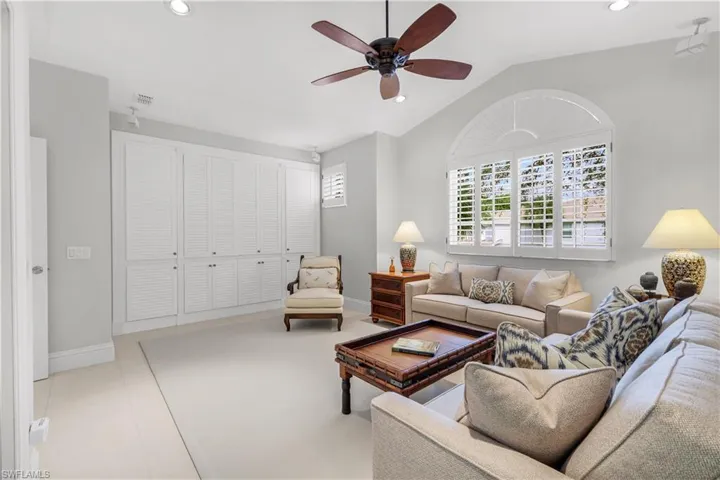 Living room featuring lofted ceiling, recessed lighting, and ceiling fan