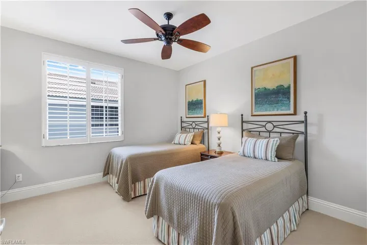 Bedroom featuring light colored carpet and ceiling fan