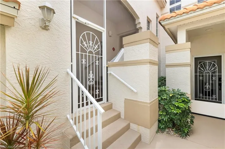 Entrance to property featuring stucco siding and a tile roof