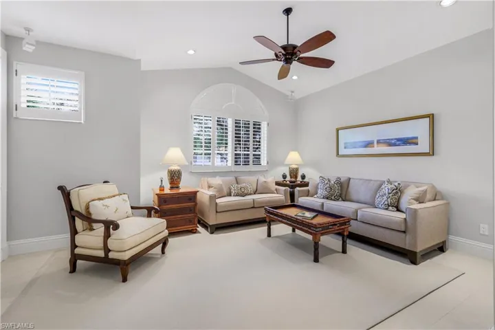 Living room with plenty of natural light, vaulted ceiling, a ceiling fan, and recessed lighting