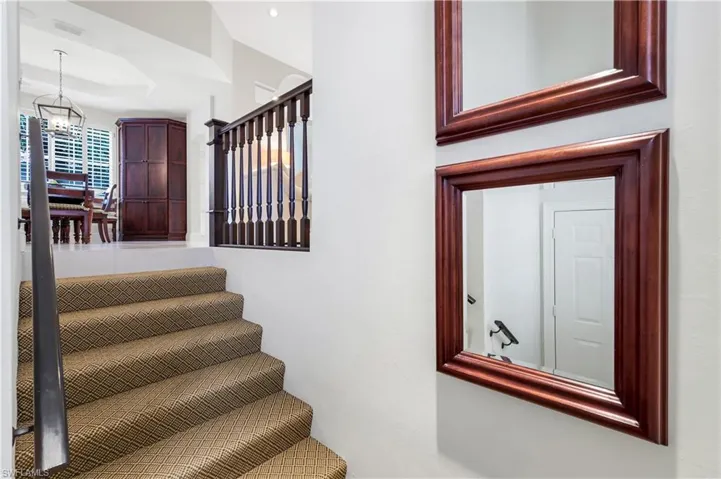 Stairway featuring a raised ceiling
