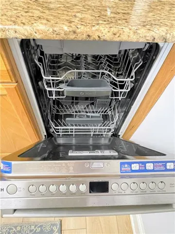 Kitchen view of dishwasher and light countertops