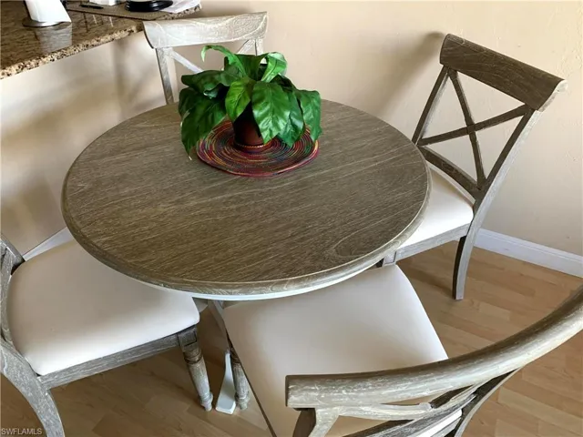 Dining space featuring wood finished floors and baseboards