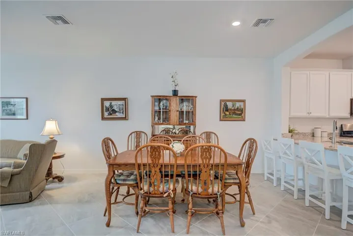 Dining space with recessed lighting and light tile patterned floors