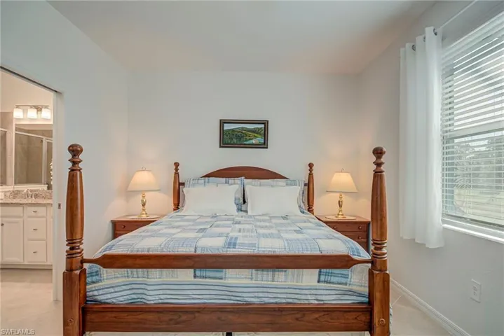 Bedroom with baseboards and ensuite bath