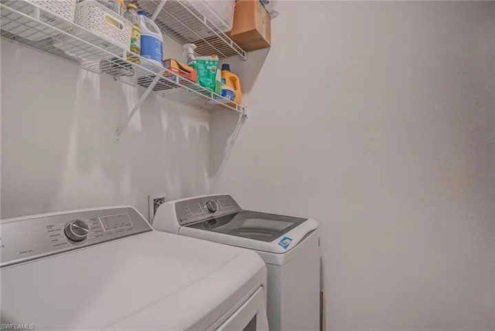 Laundry room with washing machine and clothes dryer