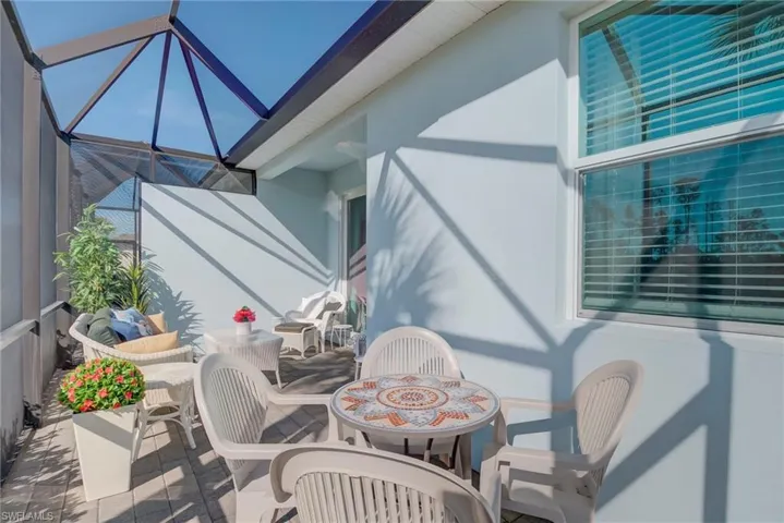 Balcony with a sunroom and outdoor dining area