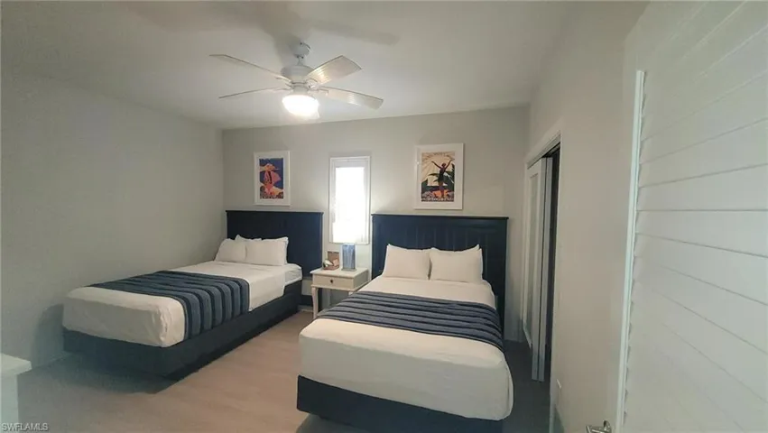 Bedroom featuring a closet, wood finished floors, and a ceiling fan