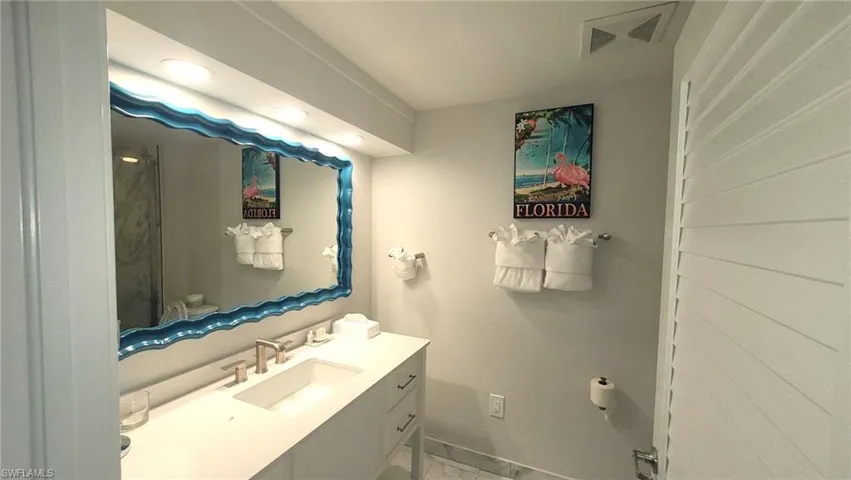 Bathroom featuring vanity, baseboards, and visible vents