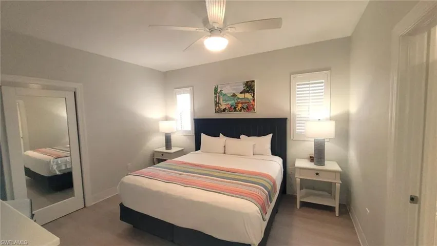 Bedroom with baseboards, multiple windows, and ceiling fan