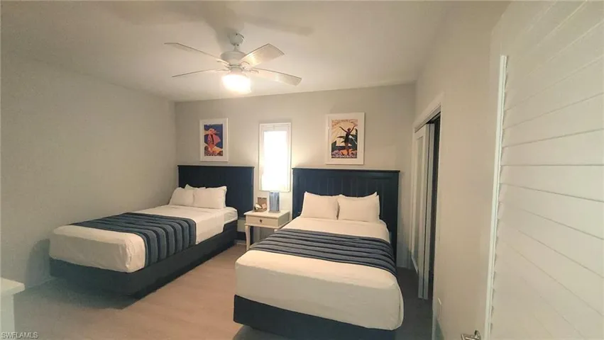 Bedroom featuring a closet, ceiling fan, and wood finished floors