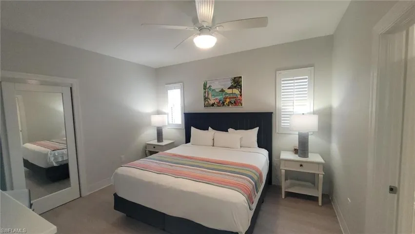 Bedroom featuring a ceiling fan, baseboards, and wood finished floors