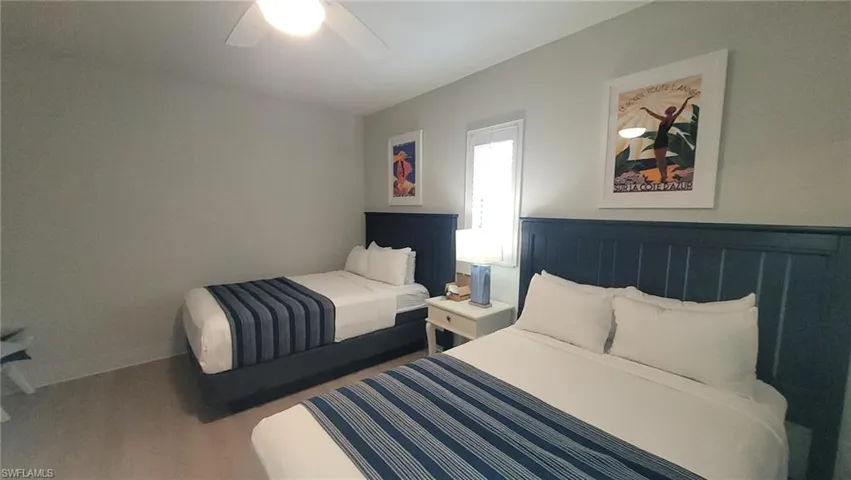 Bedroom with baseboards, ceiling fan, and wood finished floors