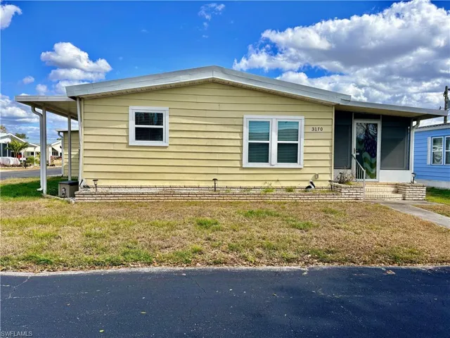 View of front of property with a front yard and entry steps