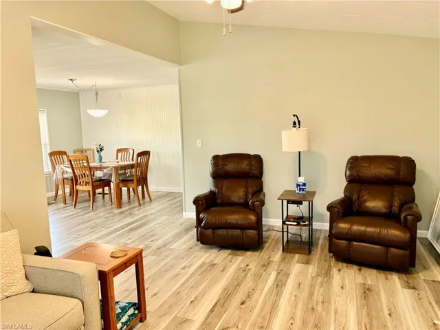 Living area featuring light wood-style floors and lofted ceiling