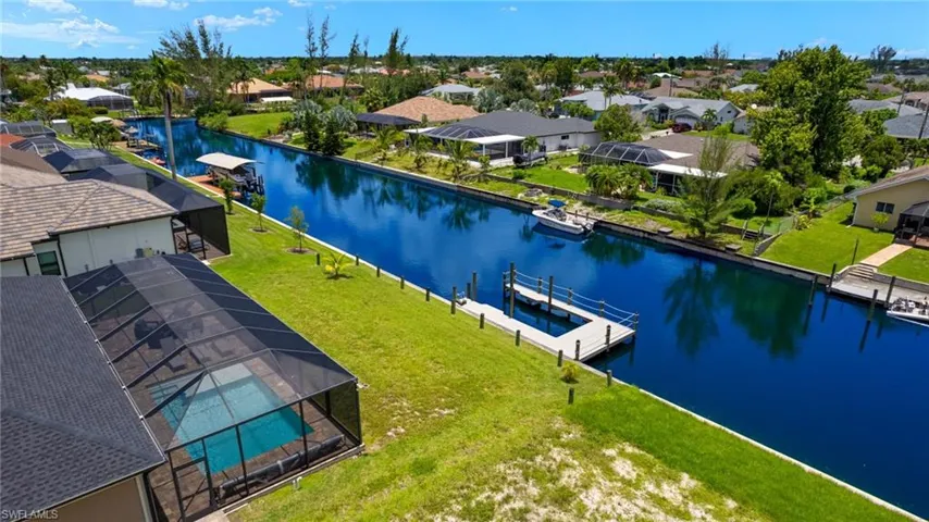 Birds eye view of property with a water view