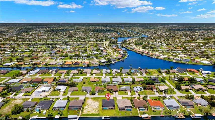 Birds eye view of property with a water view
