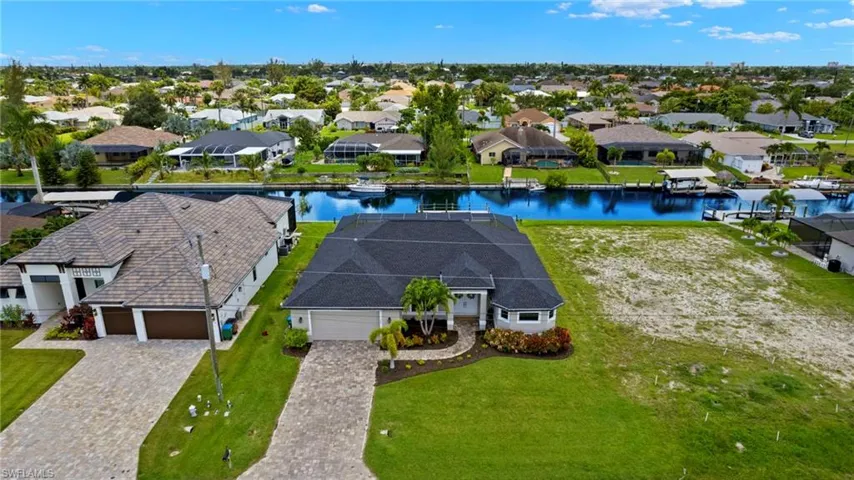 Birds eye view of property with a water view