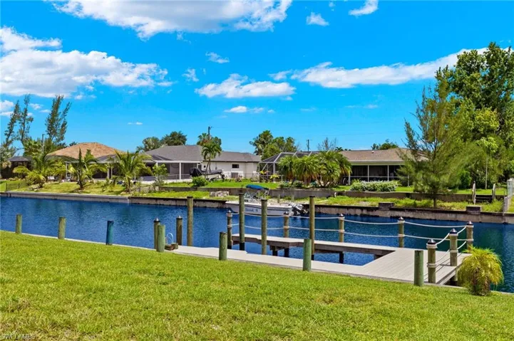 Dock area featuring a water view and a yard