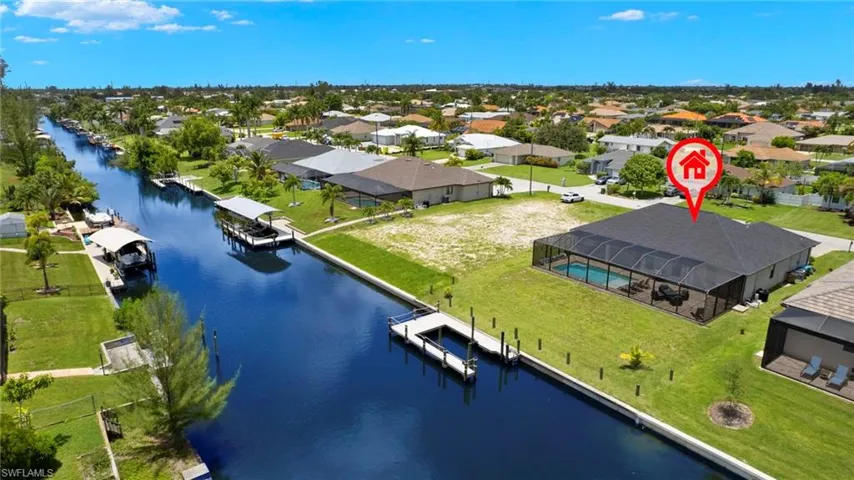 Birds eye view of property with a water view